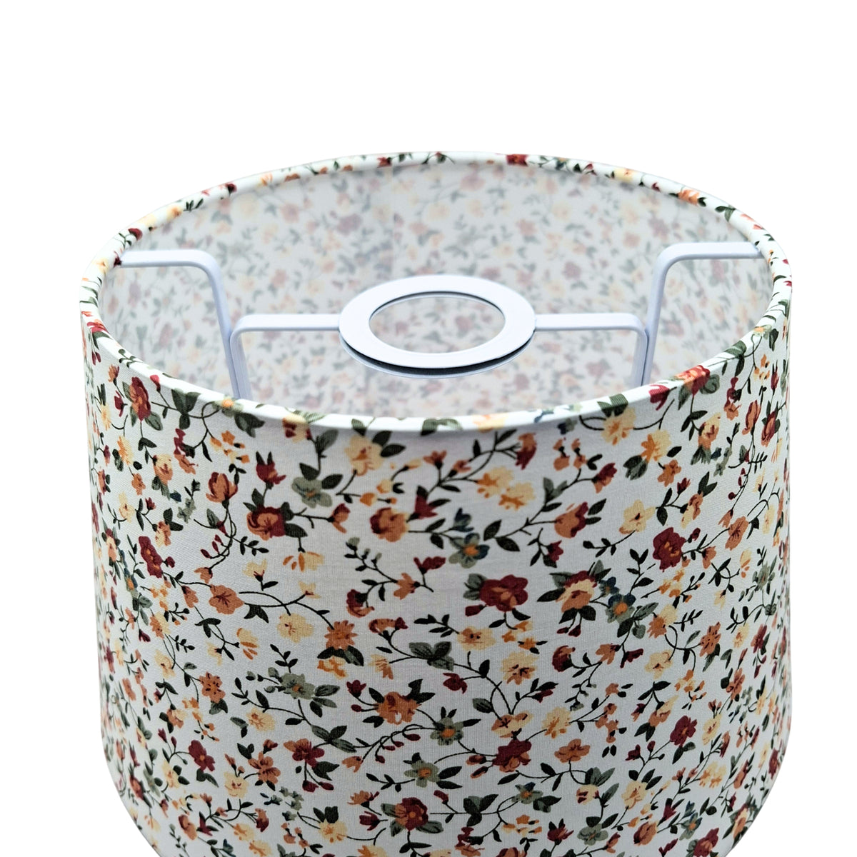 A charming cream lampshade adorned with floral patterns. Perfect for adding a bohemian touch to your vintage decor.
