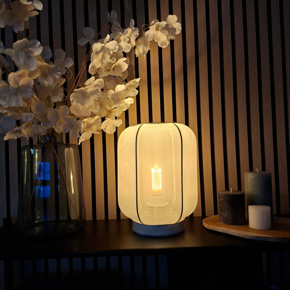 A soft cream table lamp with a minimalist Japandi design. Perfect for adding warmth and elegance to any tabletop.