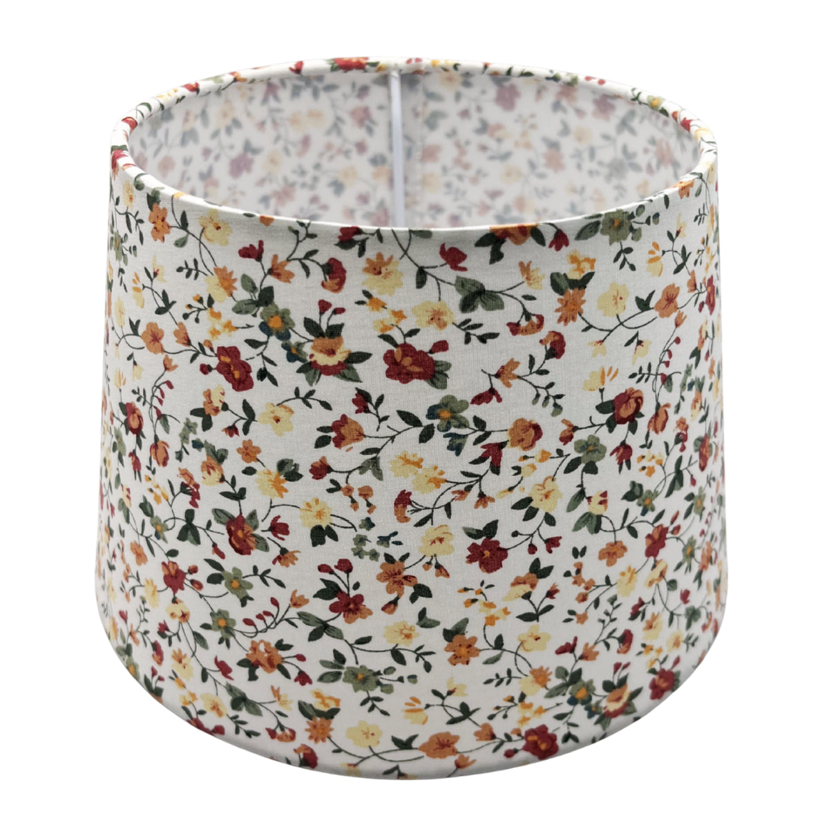 A side view of a cream lampshade, exuding timeless charm. Perfect for adding a soft glow to any interior setting.