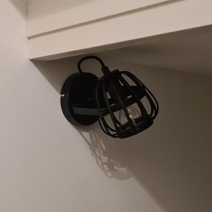The black Nature Trapeze ceiling light showcases a rustic charm.