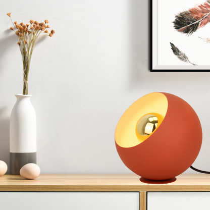 A vibrant red table lamp that adds a pop of color to any modern decor. Perfect for creating a cozy reading nook.