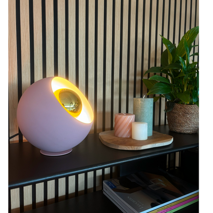 A modern pink table lamp that adds a playful touch to your decor. Perfect for creating a cozy ambiance.