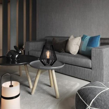 Illuminate your workspace with the Tavola table lamp in sleek black. Its industrial style adds a modern touch to any desk.